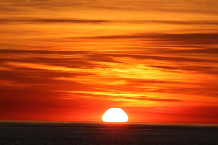 a sunset over a body of water